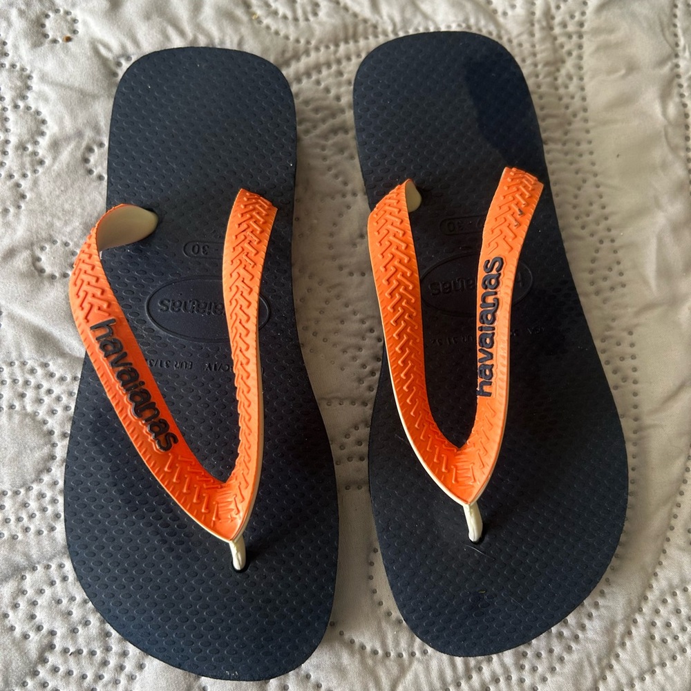 Havana’s flip flops size 29/30 (11-12). Navy base w/orange strap. Great shape!